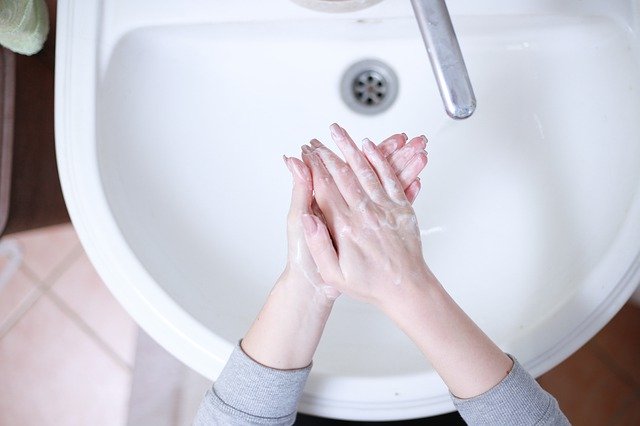 Woman washing hands to limit spread of coronavirus